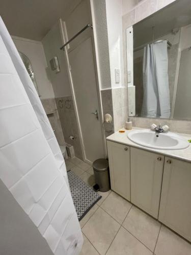 a bathroom with a sink and a shower at Canterbury Escapes 2 bedrooms in Kent