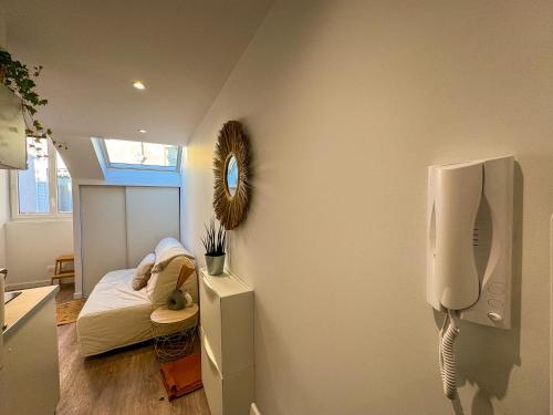 une chambre avec un lit et un urinoir sur un mur dans l'établissement Le petit Jean - Studio hyper centre, à Grenoble