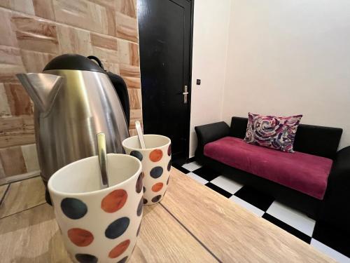two polka dot vases sitting on the floor in a living room at Casablanca Central Suites - Casa Port in Casablanca