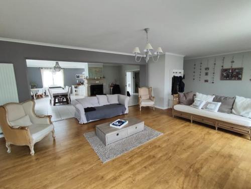 un salon avec un canapé et une table dans l'établissement Maison 240+65m2, piscine, spa, sauna, salle sport, à Saint-Rambert-sur-Loire