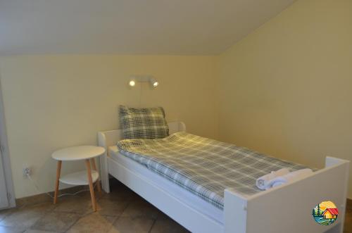 a small bedroom with a bed and a stool at Villa 13 in Étrembières