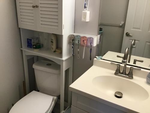 a bathroom with a white sink and a toilet at Cozy room in Kitchener