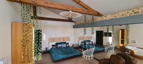 a living room with two beds and a couch at CHEZ PAM agréable chambre d’hôte pour les amoureux in Marmande