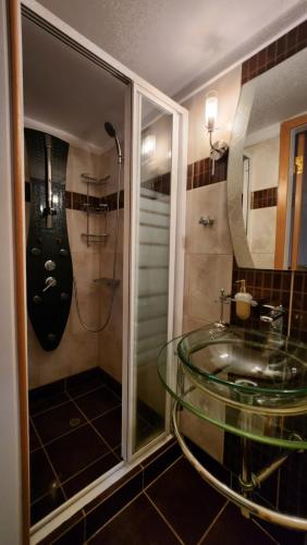 a bathroom with a glass sink and a shower at Nian Apartments - by Avelink in Spáta