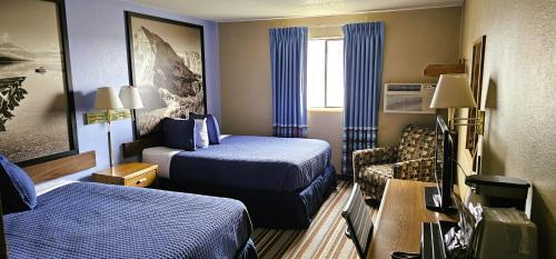 a hotel room with two beds and a couch at Grizzly Inn in Great Falls