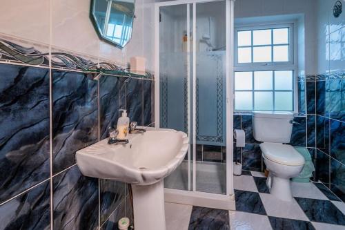 a bathroom with a sink and a toilet at Mullally House Liscannor (Wild Atlantic Way) in Liscannor