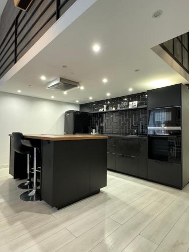 a kitchen with black cabinets and a wooden counter top at 4 you in Budapest