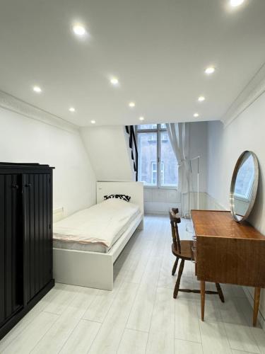 a bedroom with a bed and a desk and a mirror at 4 you in Budapest