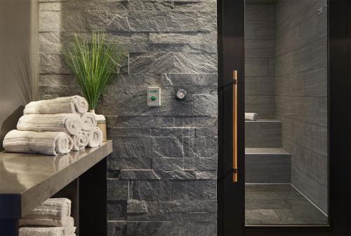 a bathroom with a stone wall at InterContinental Minneapolis - St. Paul Airport by IHG in Minneapolis