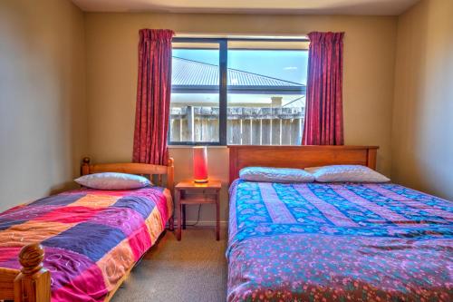 a bedroom with two beds and a window at 20 Rippingale Road in Hanmer Springs