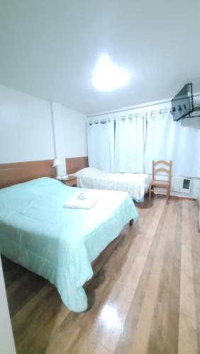 Ένα ή περισσότερα κρεβάτια σε δωμάτιο στο Hotel Alvear Jujuy