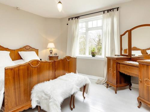 a bedroom with a bed and a desk and a mirror at 6 person holiday home in Søby Ærø-By Traum in Havrekobbel