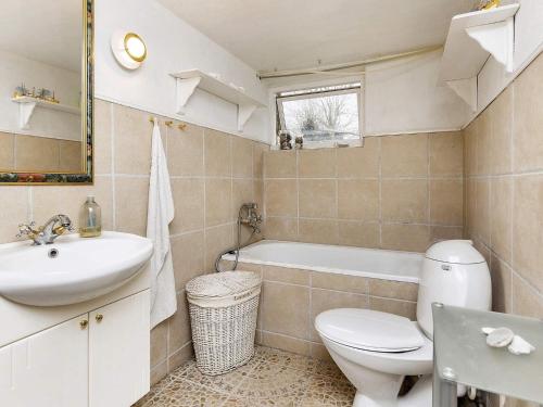 a bathroom with a toilet and a sink and a tub at 6 person holiday home in Søby Ærø-By Traum in Havrekobbel