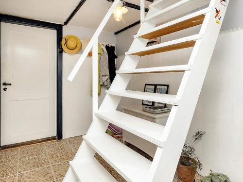 a white staircase in a room with a door at 6 person holiday home in Søby Ærø-By Traum in Havrekobbel
