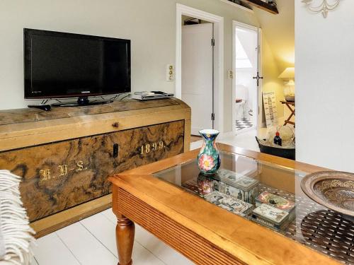 a living room with a tv on top of a wooden table at 6 person holiday home in Søby Ærø-By Traum in Havrekobbel