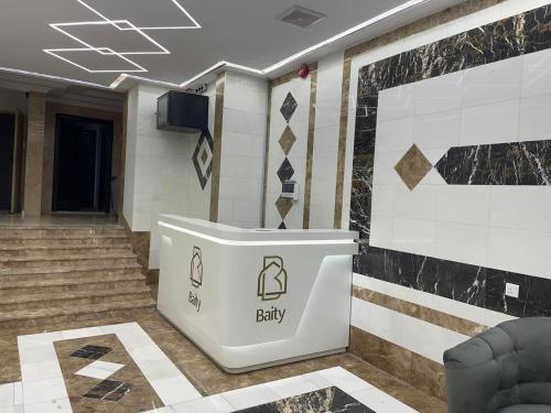 a lobby with a baby sign on the wall at فندق العز بيتي in Al Madinah
