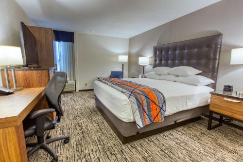 a hotel room with a bed and a desk at Drury Inn and Suites St Louis Collinsville in Collinsville