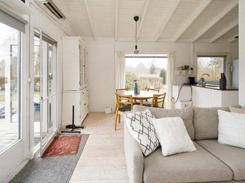 a living room with a couch and a table at 4 person holiday home in Græsted-By Traum in Græsted