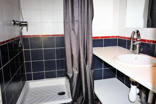 a bathroom with a sink and a shower curtain at Résidence Roches Rouges A - 2 Pièces pour 4 Personnes 971 in Tignes