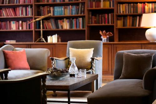 a living room with two chairs and a coffee table at The Olde Bell, BW Signature Collection in Marlow