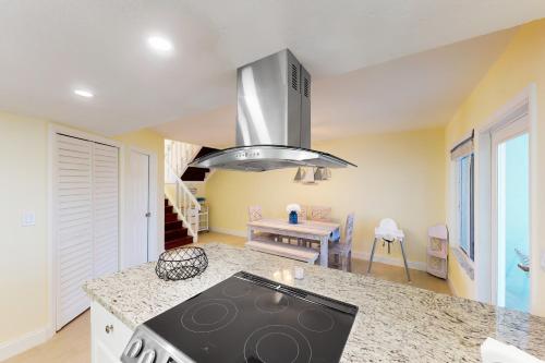 a kitchen with a stove top oven in a room at KCB Canal Livin' in Key Colony Beach