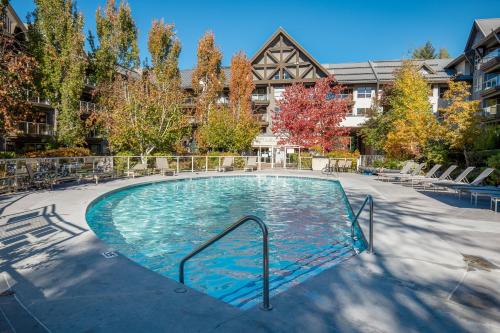 a swimming pool in the middle of a building at 2BR in The Aspens, Ski In, Ski Out, Pool and Hot Tub, Gas Fireplace, Ski Valet, Gym in Whistler