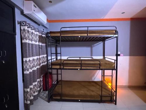 a room with two bunk beds in a room at zooFamily in Dhaka