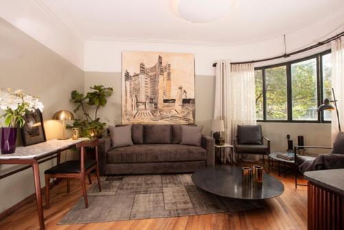 a living room with a couch and a table at Hotel Edificio Republica in Mexico City