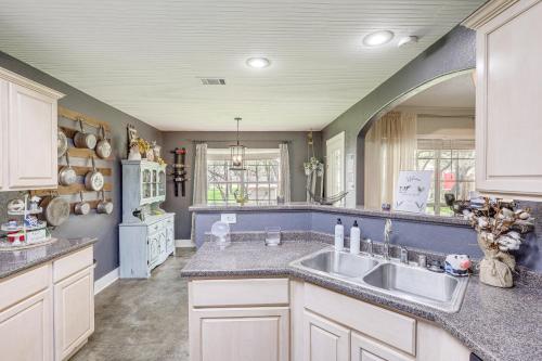 a kitchen with a sink and a large mirror at 5 Mi to Belton Lake Peaceful Home with Hot Tub in Belton