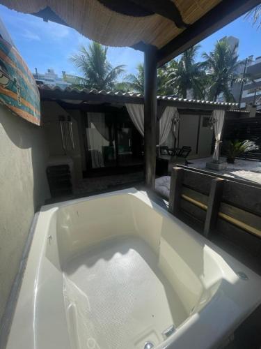 a large bath tub sitting on top of a patio at Casas Bravo in Itajaí