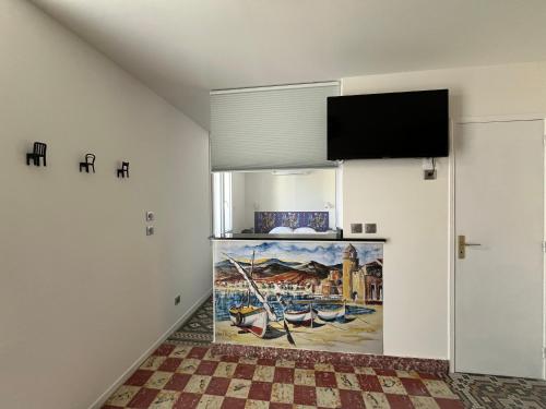 Телевизор и/или развлекательный центр в Maison de Majorque-Appartements