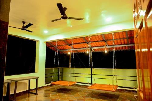 a room with a large window with a ceiling fan at Anant Villa Chaul Alibaug Near Nagav Revdanda Beach in Alibag