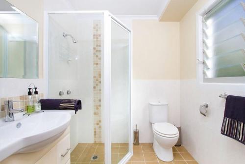 a white bathroom with a sink and a toilet at Ships Ahoy in Kiama
