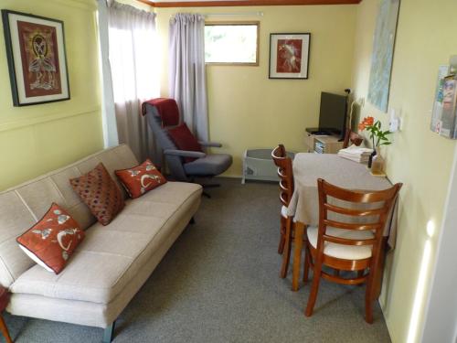 a living room with a couch and a table at Ligita's Homestay in Havelock