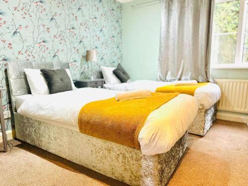 a bedroom with two beds and a window at The Esplanade Lodge-Free Parking in Strood