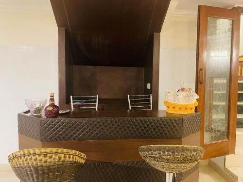 a kitchen with two chairs and a counter at Own stay Chhaterpur in New Delhi