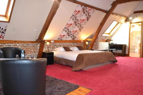a bedroom with a bed and a red carpet at Le Domaine des Cigognes in Ennevelin