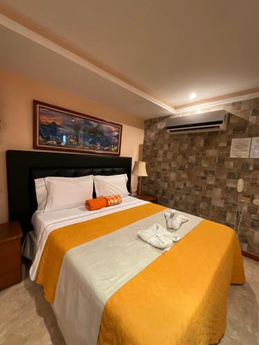 um quarto com uma cama grande e toalhas em HOTEL MUEVETE POR VARGAS em Catia La Mar