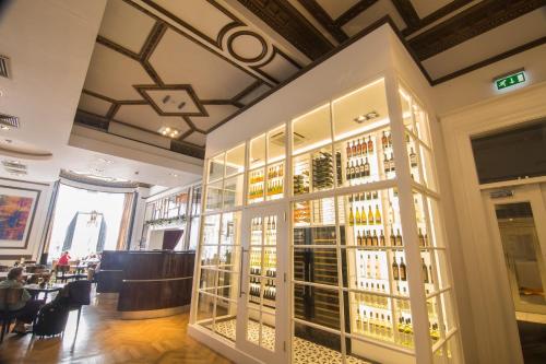 a wine tasting room with a large glass display of wine bottles at Hotel Indigo - Edinburgh - Princes Street by IHG in Edinburgh