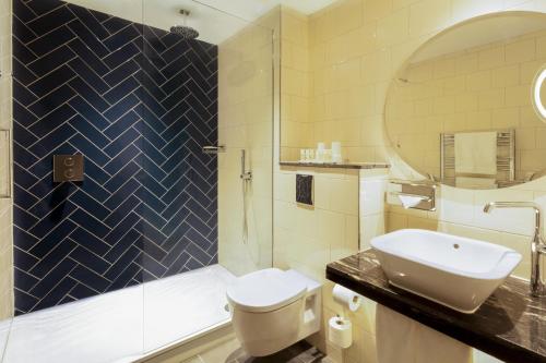 a bathroom with a toilet and a sink and a shower at Hotel Indigo - Edinburgh - Princes Street by IHG in Edinburgh