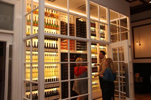 a group of people standing in front of a wine store at Hotel Indigo - Edinburgh - Princes Street by IHG in Edinburgh