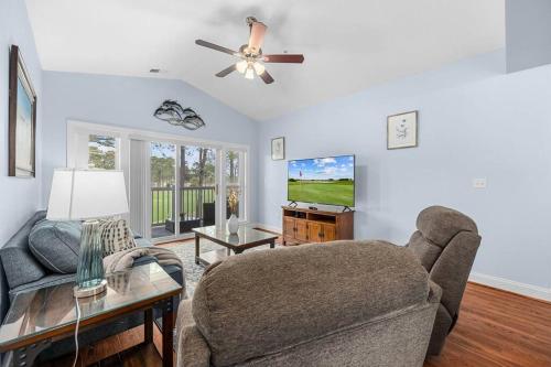 a living room with a couch and a tv at Gorgeous 3BR 3BA Villa W/Amazing Views Near Beach in Myrtle Beach