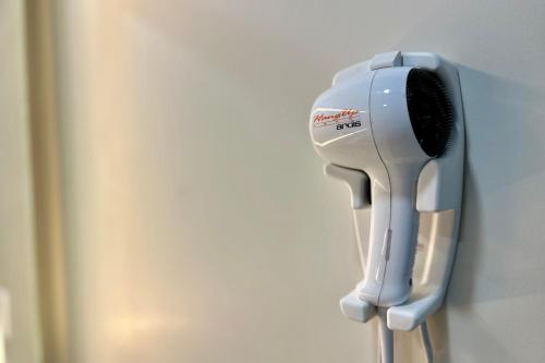 a hair dryer is hanging on a wall at Hyland Inn near Pasadena Civic Center in Pasadena