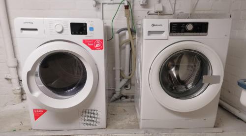 two washing machines sitting next to each other at 2 Room Apartment 15min to Fair in Hannover