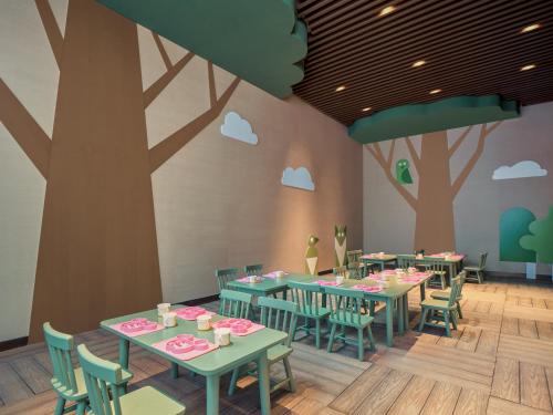 a rendering of a restaurant with tables and chairs at HUALUXE Kunshan Huaqiao by IHG - F1 Racing Preferred Hotel in Kunshan