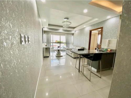 a large kitchen and living room with a table in it at beautiful penthouse Santo Domingo in Santo Domingo