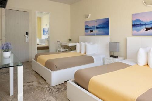 a hotel room with two beds and a table at Ocean Five Hotel in Miami Beach