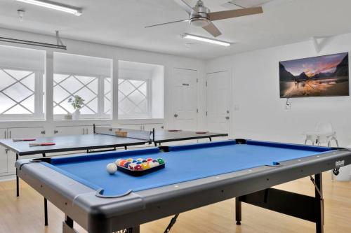 two ping pong tables in a room at New cheerful villa, Pool, Spa, Mini Golf, Game room, Fire pit next to Disneyland in Anaheim