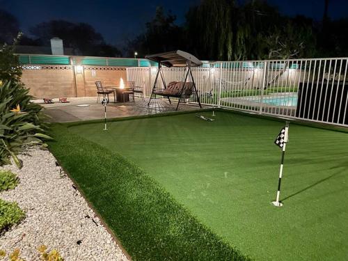a miniature golf course in a backyard at night at New cheerful villa, Pool, Spa, Mini Golf, Game room, Fire pit next to Disneyland in Anaheim