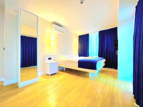 a bedroom with a bed and a large mirror at ORBI CITY batumi in Batumi